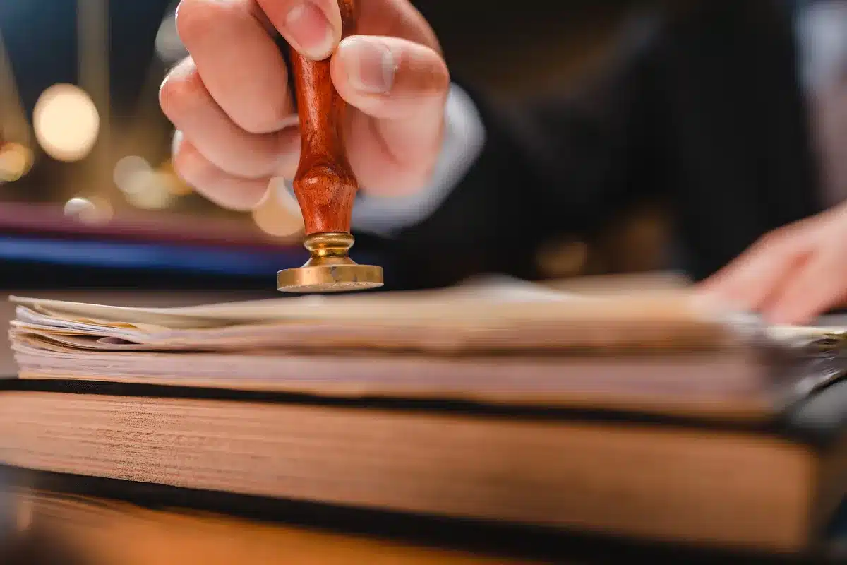 Image of a person signing documents and providing notarial and legalisation services