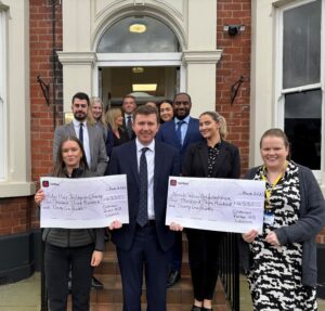 Mike Prendergast and colleagues at Dickinson Parker Hill present cheques to local charities
